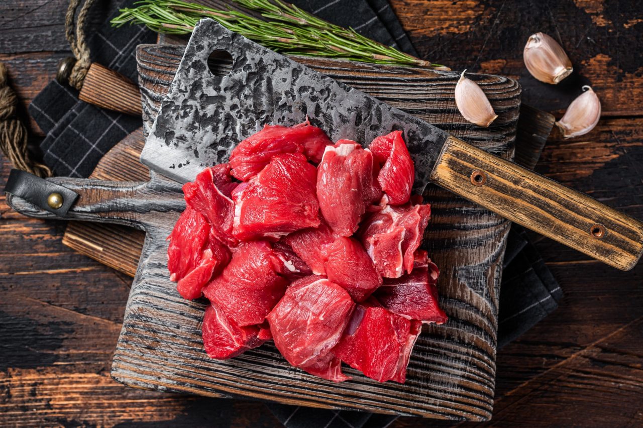 Raw chopped beef veal meat on butcher board wooden background top view.jpg