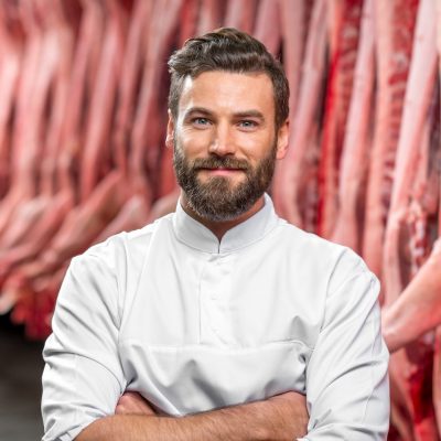 Portrait of a handsome butcher at the manufacturing e1674720981249.jpg